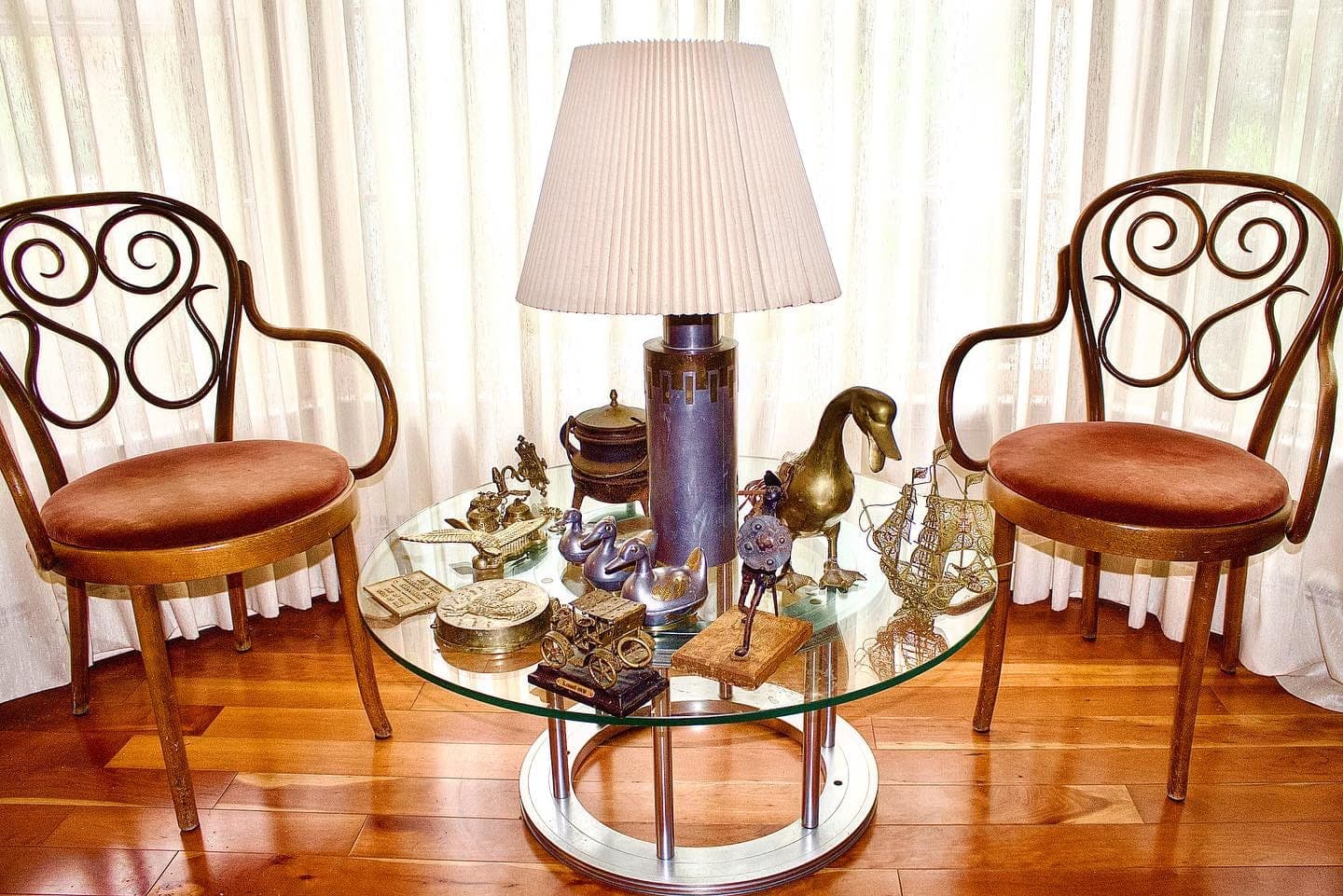 Table of silver and brass collectibles priced and tagged for a Black Dog estate sale