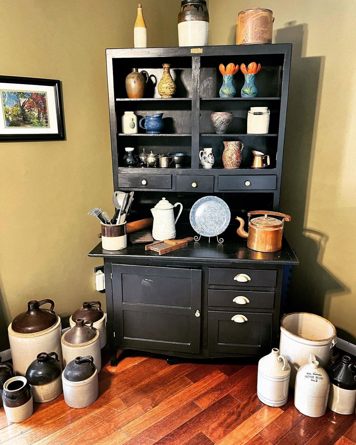 Antique black hutch with pottery and stoneware crocks from a Black Dog estate
