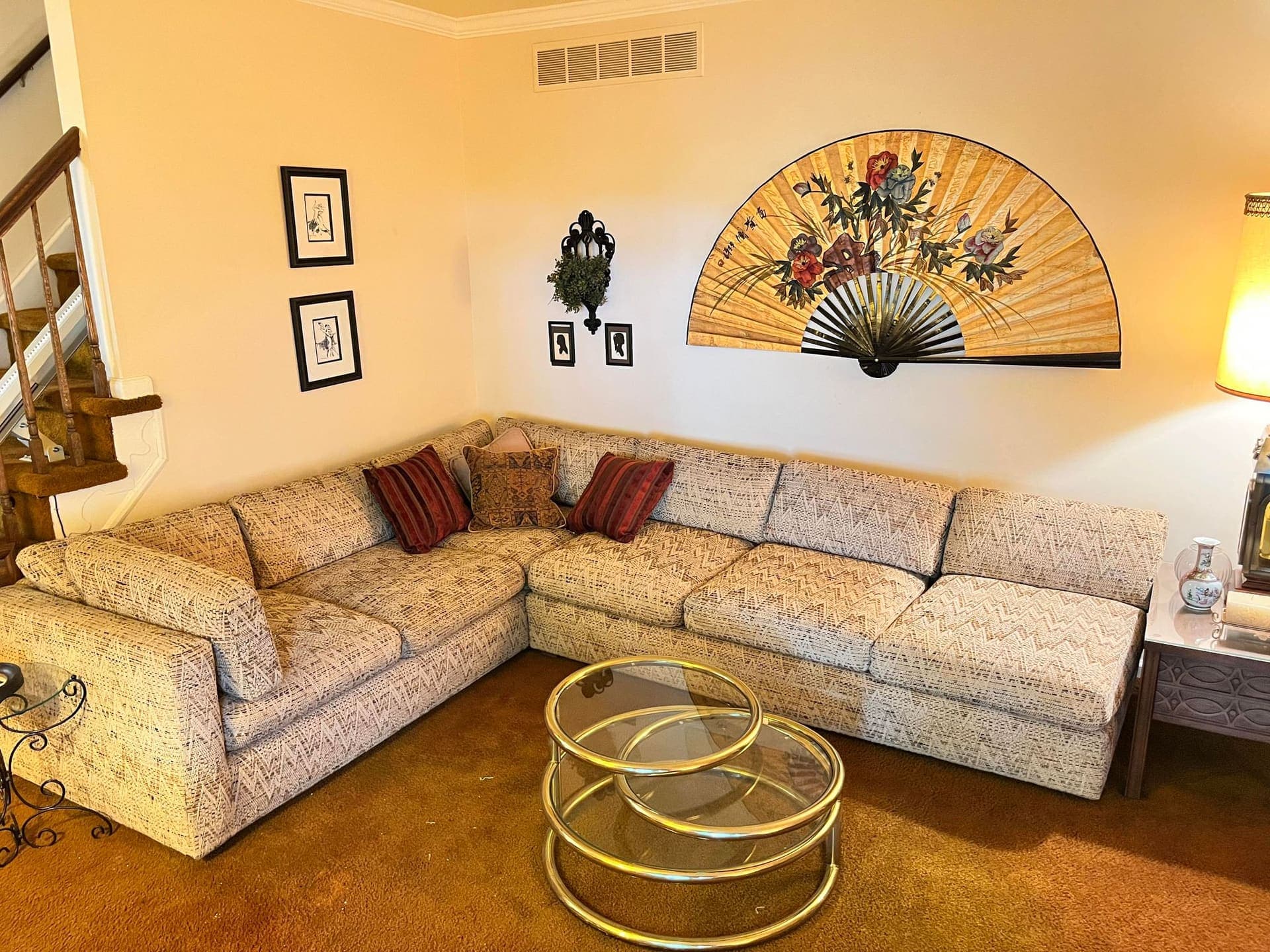 Vintage living room with sectional sofa and wall art cataloged for a Black Dog estate auction